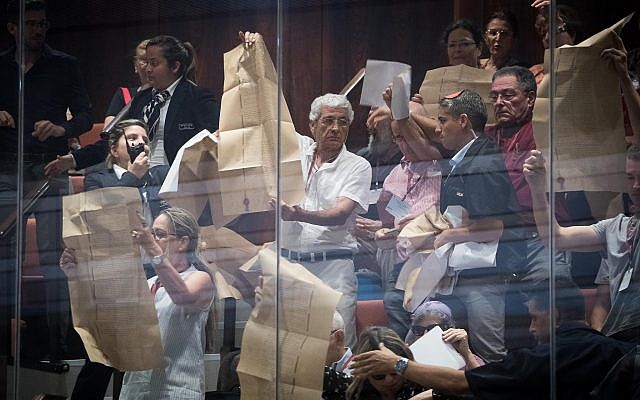 Activists wave Declaration of Independence in stormy Knesset nation-state debate