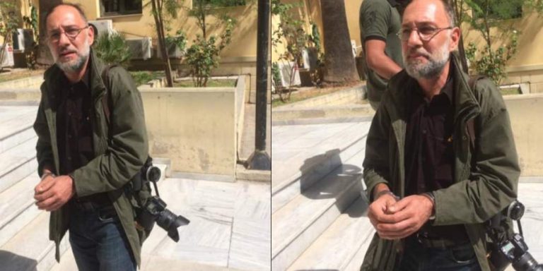 Police handcuffs, arrests photojournalist Stamatiou during squat evacuation
