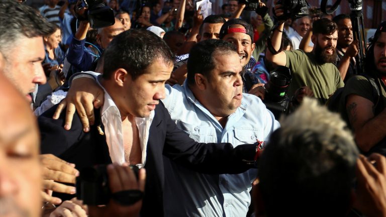 ‘Murderer!’ Protests and fights erupt as Guaido arrives at Venezuelan airport, gets booed and DOUSED with water