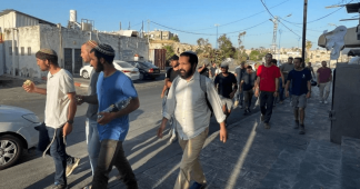 Armed settlers roam streets as mosque attacked and night curfew ordered