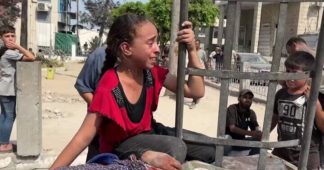 Young girl mourns her mother as she accompanies her body