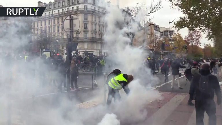 Tear gas & bonfires: Scuffles with police as Yellow Vests block roads in Paris ahead of 1st anniversary of protests
