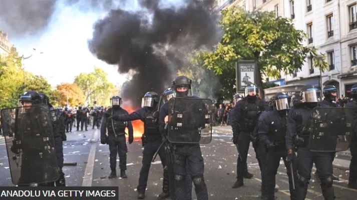 French police fire tear gas at school protesters as officer charged over student hit by projectile